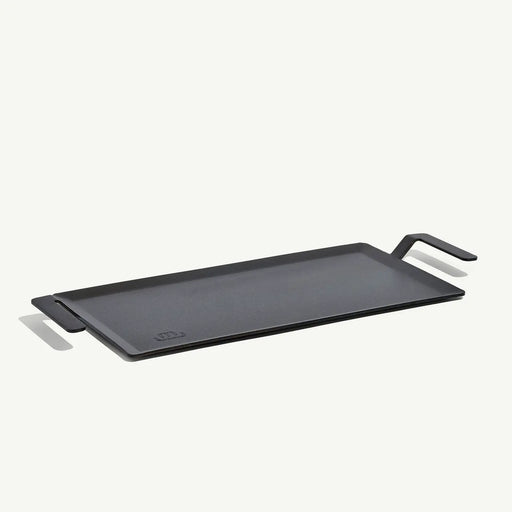 Made In | Carbon Steel Griddle features a flat-top design with low sides, ergonomic handles, and fits over two burners for versatile stovetop or grill-top cooking.
