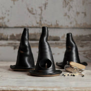 Gravesco Pottery - Witch Hat Incense Burner: Three black ceramic witch hat-shaped incense holders on wood, with glass vial and matches, perfect for spooky, witchy ambiance.
