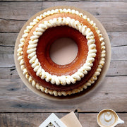 De Buyer Decor Nozzle + Adaptor Kit with cake and coffee, showcasing 26 stainless steel tips for intricate pastry designs.