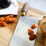 Lamson 8 Chinese Vegetable Cleaver with Walnut Handle and Leather Sheath on a cutting board, perfect for precise vegetable preparation.