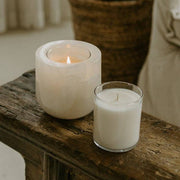Last Candle Co - White Onyx Refillable Candle: A lit marble vessel and glass container candle on rustic wood, highlighting unique stone veining and luminous glow.