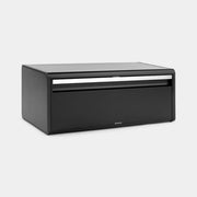 Brabantia USA Inc | Fall Front Bread Box Matt Black, a compact, wall-mountable bread box with a flat top and magnetic lid, ideal for space-saving kitchen storage.