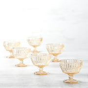 Fortessa Archie Ginger 10oz Gold Footed Dessert Bowl showcased among various glass serveware, highlighting its elegant design and craftsmanship in a curated kitchen collection.