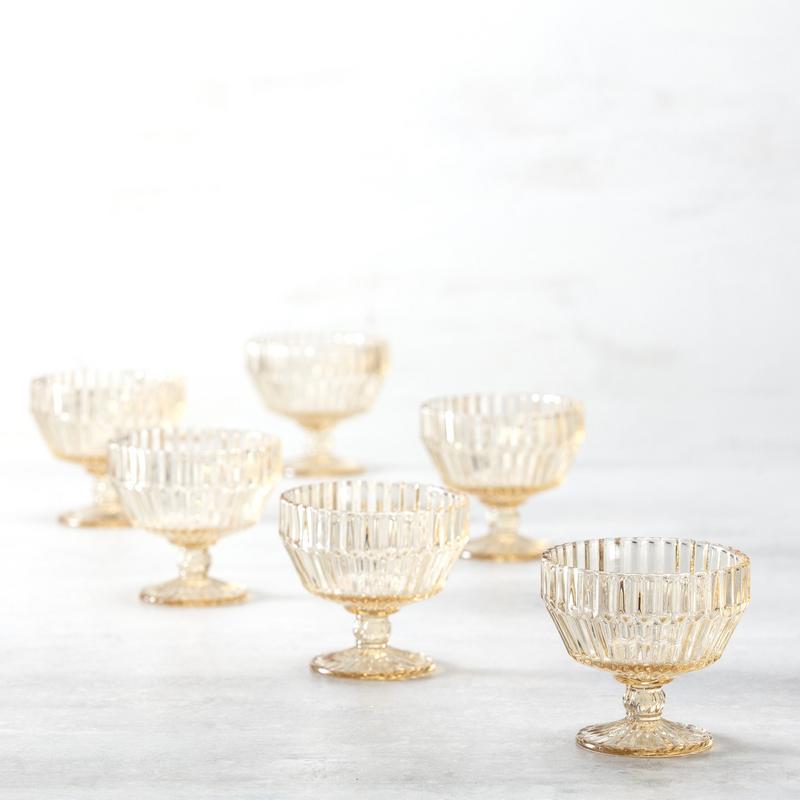 Fortessa Archie Ginger 10oz Gold Footed Dessert Bowl showcased among various glass serveware, highlighting its elegant design and craftsmanship in a curated kitchen collection.
