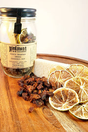 Piedmont Provisions Bourbon Peach Smash Cocktail Infusion Kit in a glass jar, featuring dried lemon slices for easy cocktail crafting.