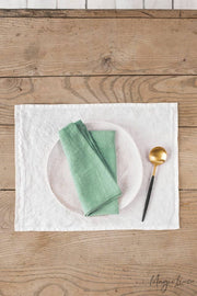 Set of 2 linen napkins on a table with a spoon, showcasing MagicLinen's versatile table decor, ideal for enhancing any dining setting.