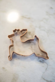 Galley and Fen - Christmas Cookie Cutters - Set of 6: Copper reindeer-shaped cutter on marble, ideal for festive baking with precision and elegance.