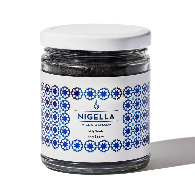 Villa Jerada - Nigella - 100g jar with white lid, featuring blue geometric label, filled with black nigella seeds, a versatile spice with health benefits.