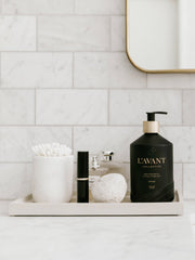 L'AVANT Collective - Fresh Linen Hand Soap in a matte black glass bottle on a tray, exemplifying eco-luxe style for elegant handwashing.