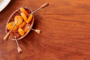 Italian Olivewood Aperitivo Bowl filled with dried apricots and small metal picks, showcasing artisanal craftsmanship from Umbria, Italy. Perfect for serving appetizers.