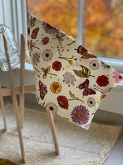 Bee's Wrap - Assorted 3 Pack - Meadow Magic, Plant-Based Wax draped over light-wood drying rack, featuring floral and butterfly prints.
