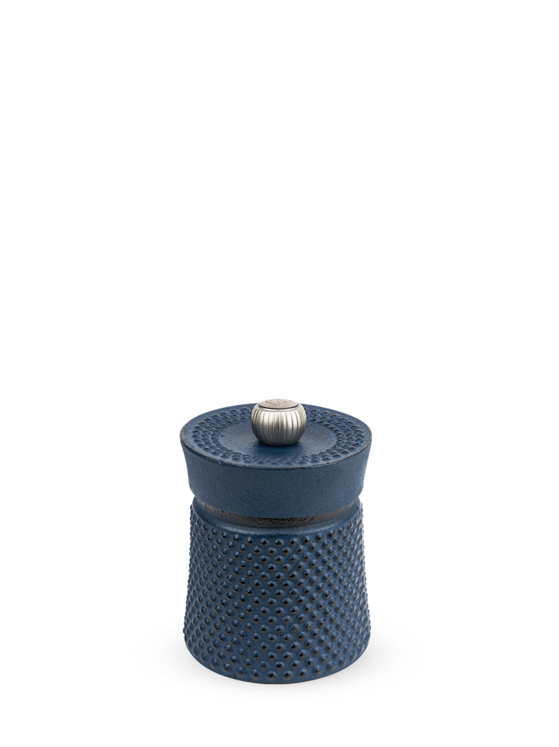 Peugeot | Bali Cast Iron Pepper Mill, Dark Blue: A compact, hobnail-textured cast-iron vessel with a silver knob, designed to enhance your pepper seasoning experience.