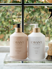 L'AVANT Collective - High Performing Dish Soap - Blushed Bergamot in matte white glass bottles with gold text, showcasing elegant design and luxurious scent.