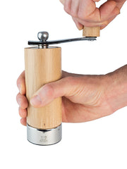 Peugeot | Isen Salt Mill, Natural: A wooden hand-held grinder with a metal base and crank handle, designed for adjustable, fine to coarse salt grinding.