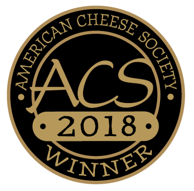 Tulip Tree Creamery - Hops: 5 Oz. Wedge, a semi-soft cheese infused with regional beer, displayed with a black and gold logo emphasizing its award-winning status.