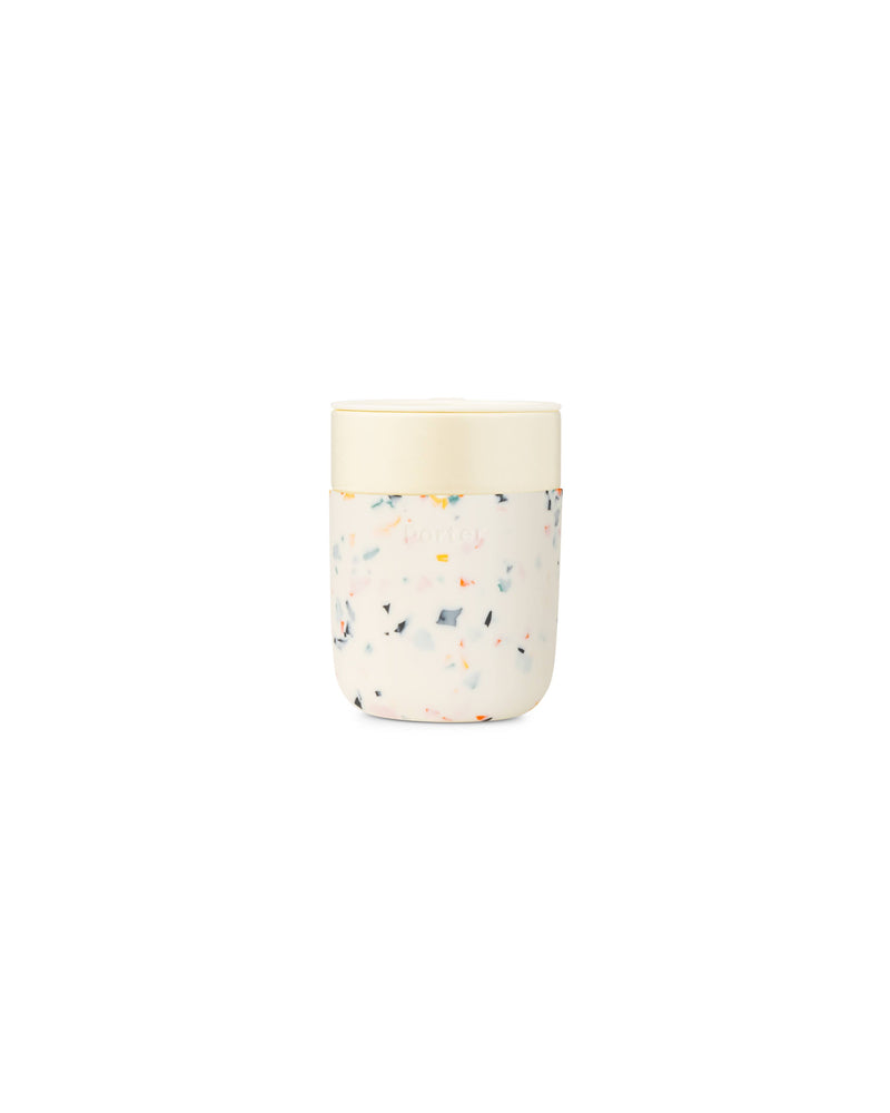 W&P - Reusable Ceramic Mug: Terrazzo Blush / 16 oz with a splash-resistant lid and silicone sleeve for a non-slip grip, perfect for reducing waste.