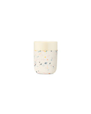 W&P Reusable Ceramic Mug: Terrazzo Charcoal, 16 oz, featuring a white lid and durable ceramic design with a soft-touch silicone sleeve for easy grip.