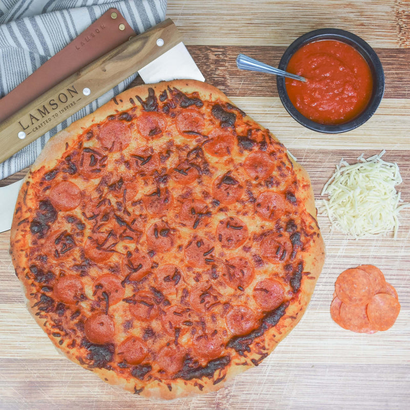 Lamson Leather Sheath for 14 Pizza Cutter/Rocker displayed with pizza. Part of a set, highlighting kitchen tools available at Athens Cooks.