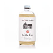Pink House Alchemy - Vanilla Bean Simple Syrup bottle, showcasing a house emblem on the label, ideal for enhancing culinary creations.