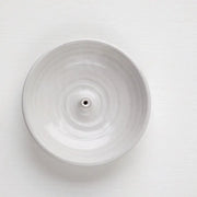 Gravesco Pottery Incense Burner: Off-white ceramic dish with a central spike for incense sticks, designed to catch ash, enhancing any kitchen or living space ambiance.