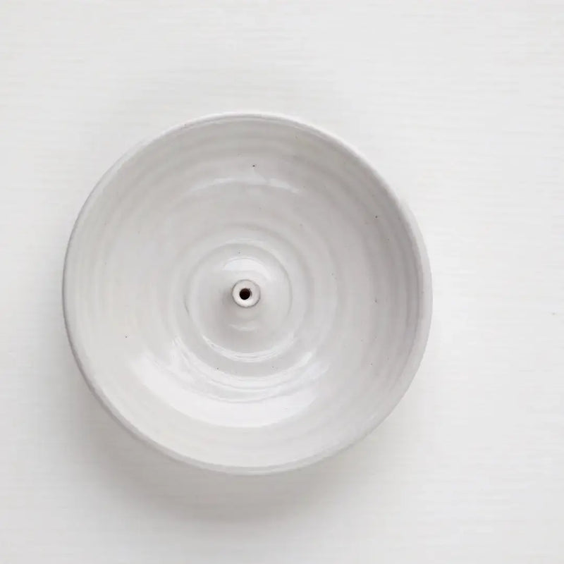Gravesco Pottery Incense Burner: Off-white ceramic dish with a central spike for incense sticks, designed to catch ash, enhancing any kitchen or living space ambiance.