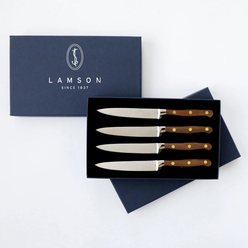 Lamson 5 Premier Forged Steak Knives- Walnut Serrated, showcasing a set of four premium German steel knives with serrated edges and walnut handles in a gift box.