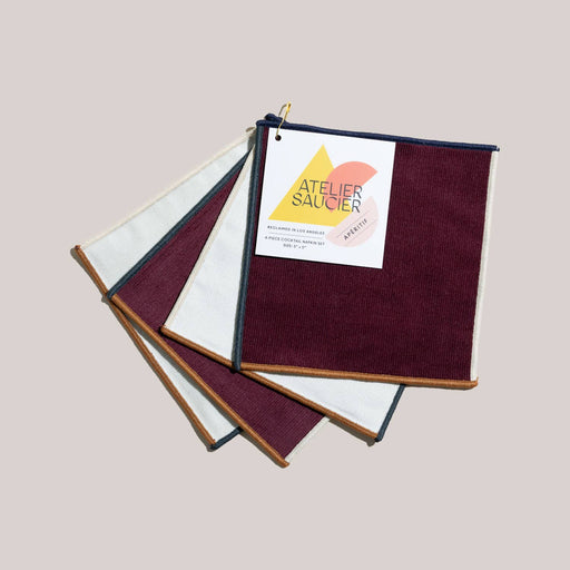ATELIER SAUCIER - Clubhouse Cocktail Napkins | Set of 4 featuring burgundy and ivory squares with contrasting trim, expertly crafted from reclaimed fabric in Los Angeles.
