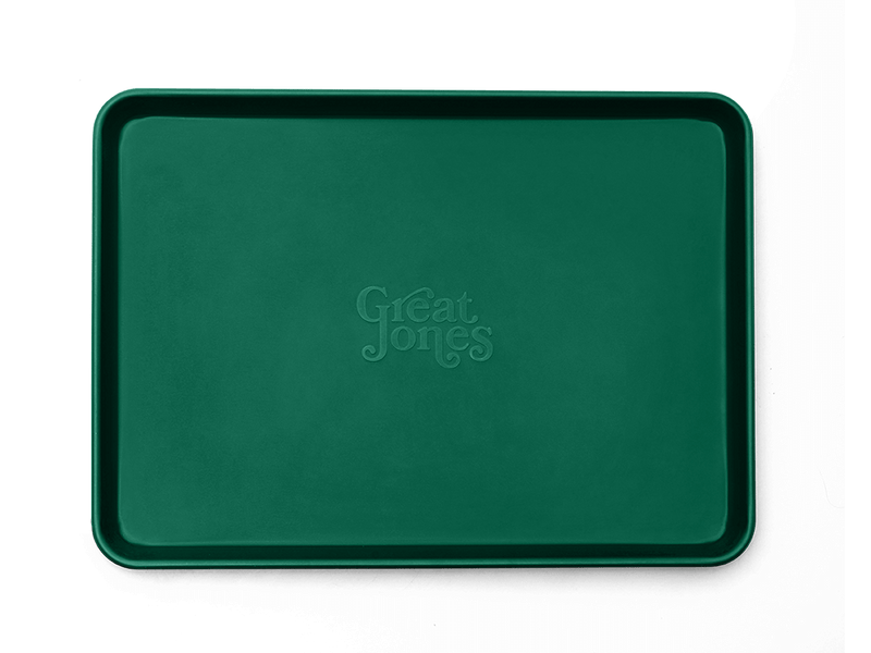 Great Jones | Holy Sheet - Pepper, a half-sized sheet pan with nonstick ceramic coating, ideal for baking and serving, showcased in bold design.