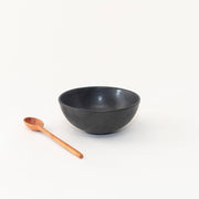 Sarah Kersten - Ramen Bowl: Black, featuring a versatile design perfect for noodles or salads, shown with a wooden spoon for serving.