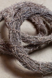 Idlewild Floral Co. - Straw Vine Wreath Base: Close-up of a woven, circular structure ideal for crafting personalized dried floral wreaths.