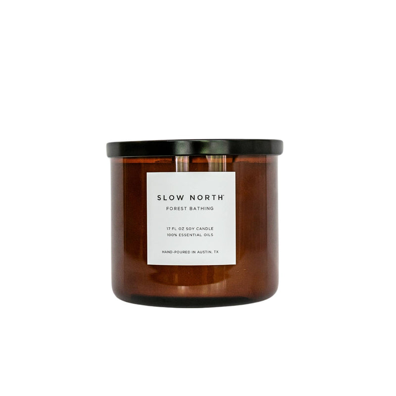 Slow North - Forest Bathing 3-Wick Soy Candle in amber jar with black lid, featuring essential oils for earthy, forest-inspired fragrance. Hand-poured, 17 oz, from Athens Cooks.