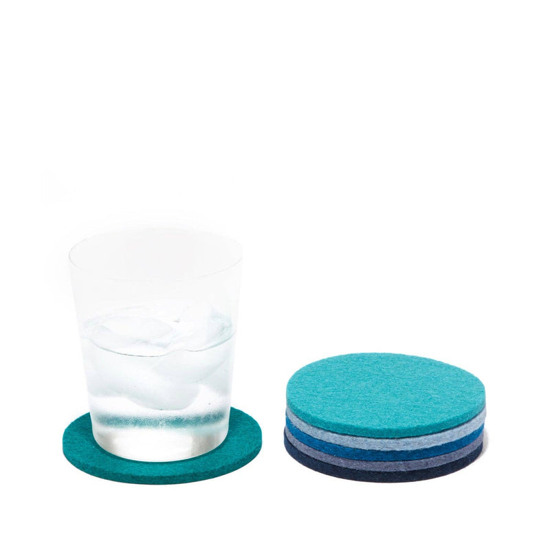 Graf Lantz - Bierfilzl Merino Wool Felt Round Coaster Multi 6 Pack: Ocean next to a glass of water with ice cubes.