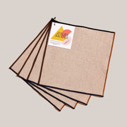 ATELIER SAUCIER - Dune Appetizer Napkins | Set of 4: Beige linen napkins with contrasting trims, clipped on a ring. Perfect for stylish gatherings.