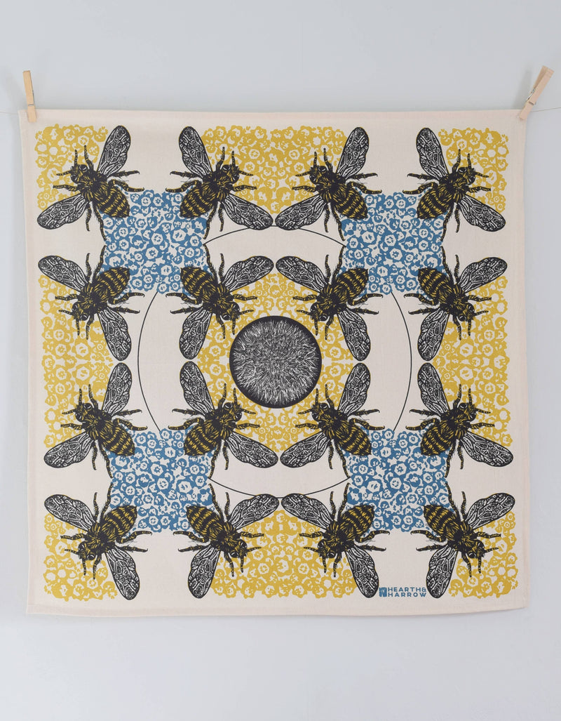 Hearth and Harrow - Honeybee Tea Towel - Organic Cotton - Oversized 30 x 30, featuring bees and honeycomb motifs, clipped to a wall for display.