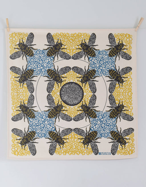 Hearth and Harrow - Honeybee Tea Towel - Organic Cotton - Oversized 30 x 30, featuring bees and honeycomb motifs, clipped to a wall for display.