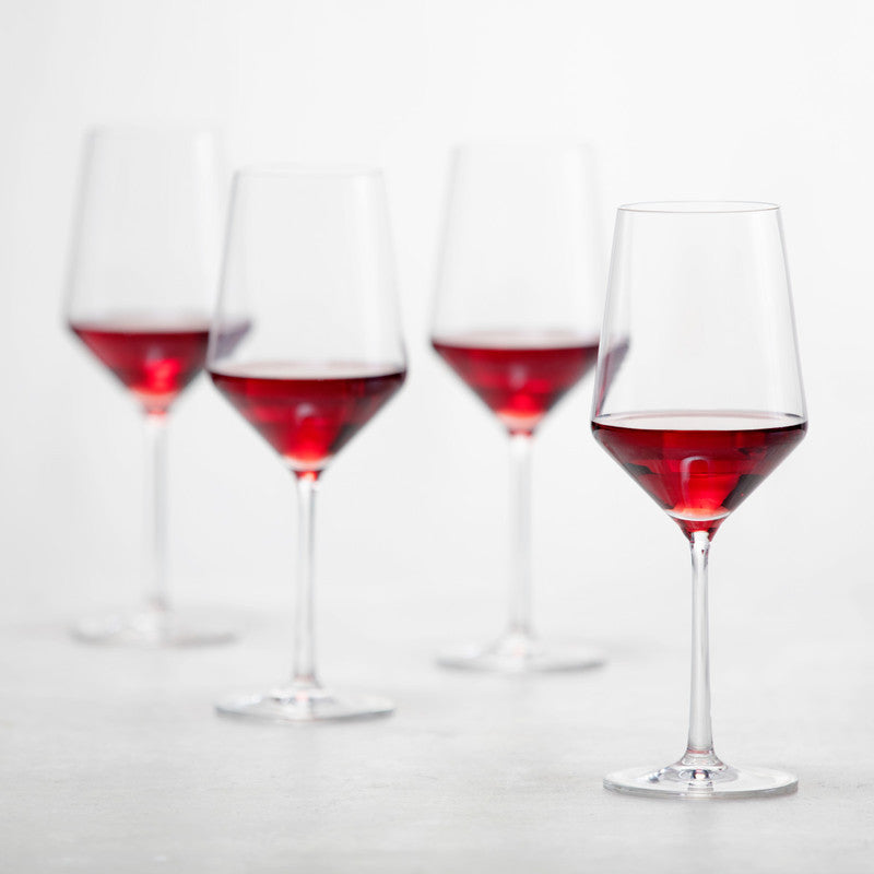 Zwiesel Fortessa | Pure Cabernet Glass, Single: A clear, elegantly designed wine glass, filled with red wine, showcasing its angled bowl and sophisticated stem, ideal for enhancing your drinking experience.