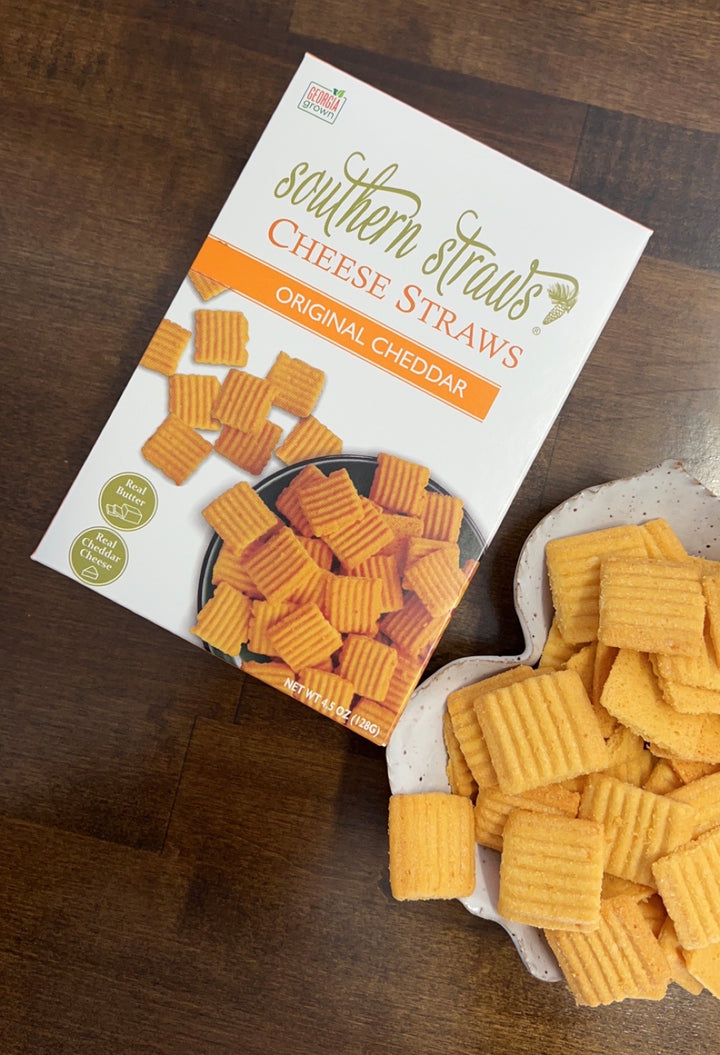 Southern Straws | Cheese Straws: Original Cheddar flavor, showcasing a box and a bowl of crispy, ridged cheese crackers, made with sharp cheddar and real butter.