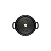 Staub | Round Cocottes - 5.5 qt Matte Black: Top-down view of a black enameled cast-iron Dutch oven with brass knob and embossed lid.
