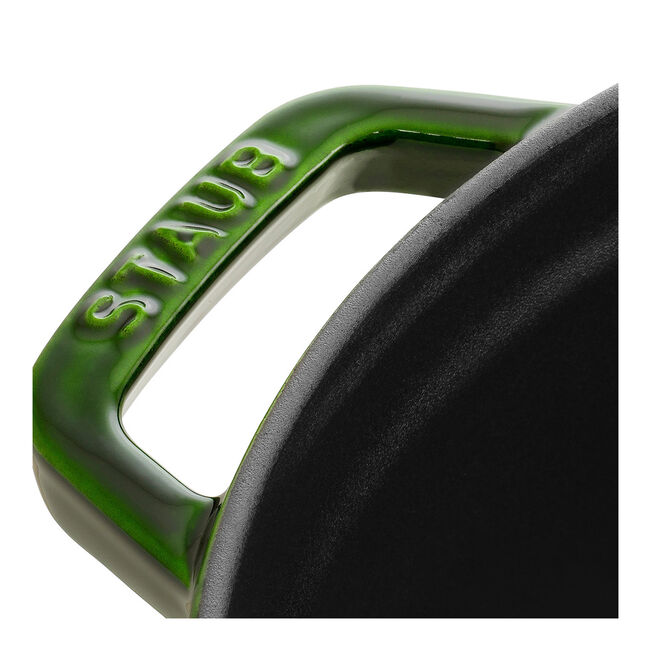 Staub | Round Cocottes - 5.5 qt Basil: Close-up of basil green handle with STAUB embossed, part of the cast iron pot with matte-black interior.