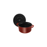Staub Round Cocotte, 4 qt Grenadine, featuring a matte black enamel interior and self-basting design, ideal for slow-cooking and enhancing meal flavors.