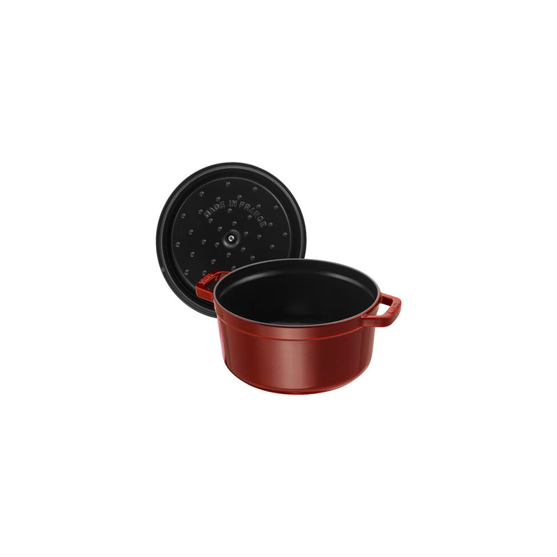 Staub Round Cocotte, 4 qt Grenadine, featuring a matte black enamel interior and self-basting design, ideal for slow-cooking and enhancing meal flavors.