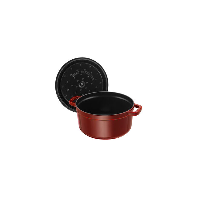 Staub | Round Cocottes - 7 qt Grenadine with self-basting lid shown, highlighting its enameled black interior and signature design, perfect for family meals.