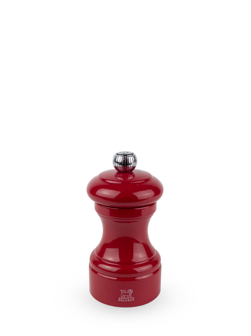 Peugeot | Bistro Pepper Mill, Passion Red: A glossy, hourglass-shaped manual grinder with adjustable coarseness, reflecting classic design from 1874, sold by Athens Cooks.