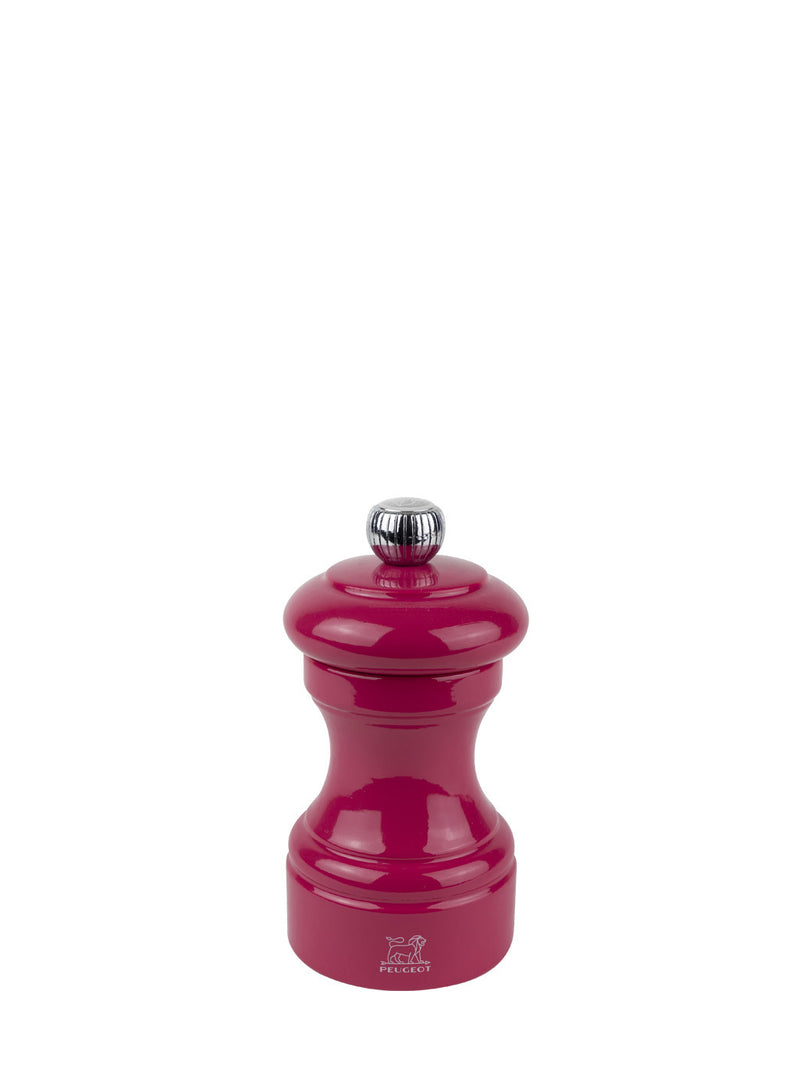 Peugeot | Bistro Salt Mill, Candy Pink: A glossy, hourglass-shaped salt mill with a metal knob for coarseness adjustment, featuring a durable steel mechanism.