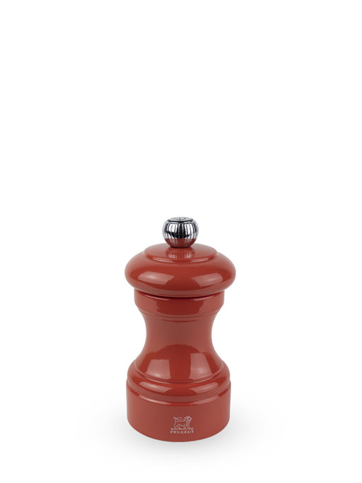 Peugeot | Bistro Pepper Mill in glossy red lacquer with chrome adjustment knob, designed for durability and gourmet precision, displaying the Peugeot logo at its base.
