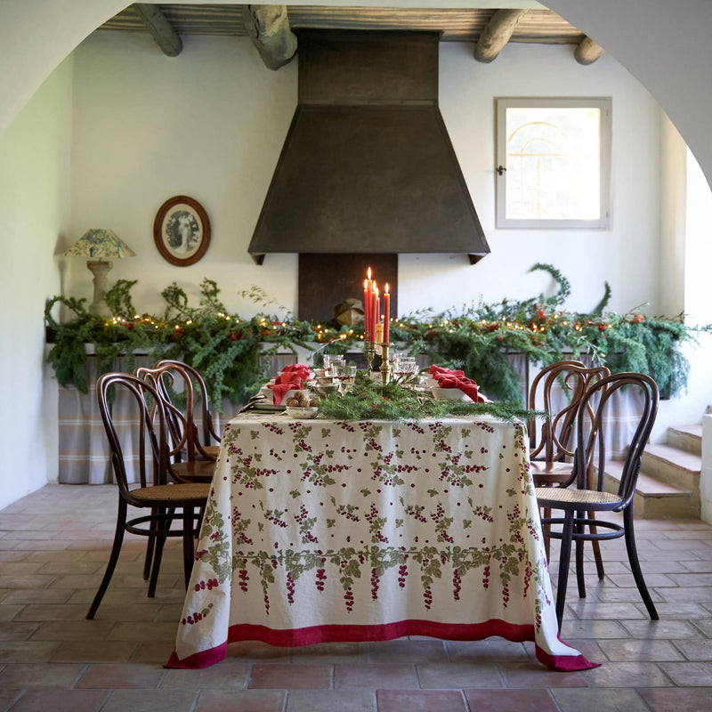 Couleur Nature - Gooseberry Red & Green tablecloth adorns a festive dining table with holly pattern, red berries, and festive decor.