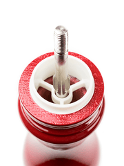 Close-up of the Peugeot Paris u'Select Wooden Salt Mill in Passion Red, showcasing its stainless-steel spout and precise grind adjustment system.