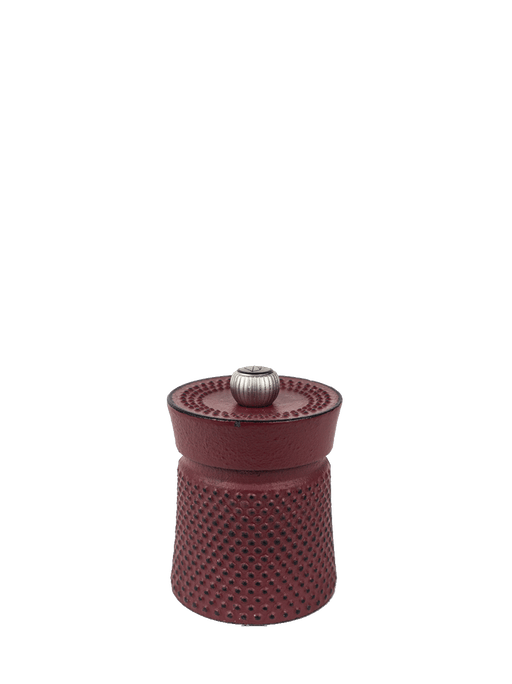 Peugeot | Bali Cast Iron Pepper Mill, Red: Compact dimpled cast-iron grinder with adjustable metal knob, combining traditional craftsmanship with modern elegance for an exquisite dining experience.