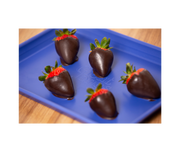 Great Jones | Little Sheet - Pepper shown with chocolate-covered strawberries, highlighting its nonstick surface, ideal for baking or serving directly on your table.