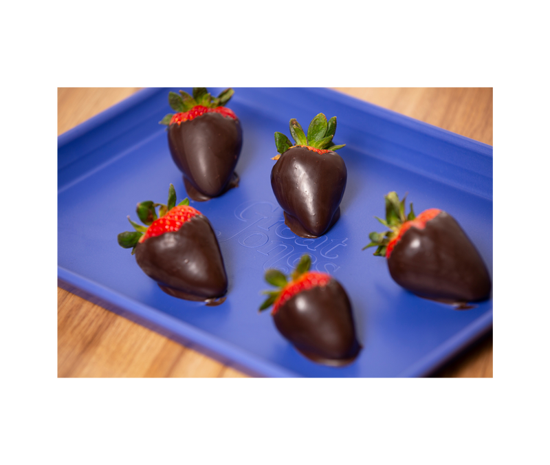 Great Jones | Little Sheet - Pepper shown with chocolate-covered strawberries, highlighting its nonstick surface, ideal for baking or serving directly on your table.